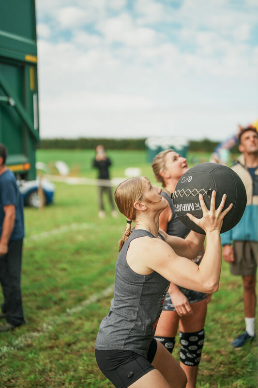 Teammates move an odd object together