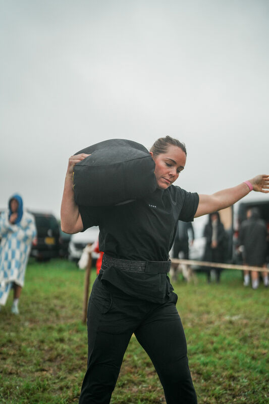 Hauling the sandbag across the grass
